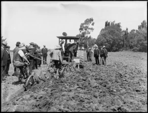 Ploughing a field using a disc harrow hauled by a tractor, possibly Christchurch area