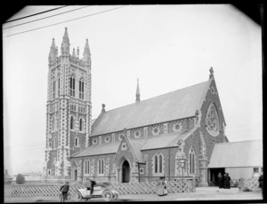 Saint Mary's Anglican Church, Timaru, with people and a motor car out the front