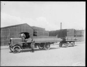 William Goss Ltd, Timber Merchants, Christchurch, with a man standing alongside a timber truck