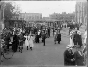 Crowds of people in Cathedral Square, Christchurch, including a tram in the background