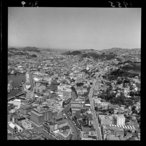 Aerial view of Wellington City looking south-east from above Thorndon, featuring Lambton Quay and Terrace areas, with a glimpse of Wellington Harbour pre 1960s reclaimation - Photograph taken by Sir Charles Madden
