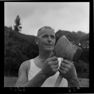 Mr E W Mitchell tests the sharpness of his axe with his thumb at the Upper Hutt Agricultural & Pastoral Show