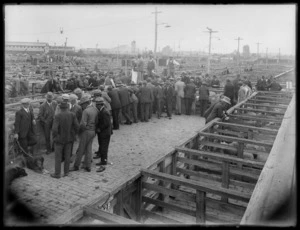 Sheep sale at a stock yards, probably Christchurch, showing (farmers ?) at pens