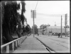 Oxford Street, Christchurch, showing a bridge on one side and advertising signage for F Turvey & Company sanitary works