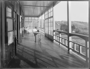 King George V Coronation Memorial Hospital, Christchurch, with a patient in his bed on the balcony
