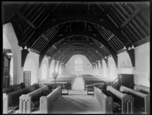 Church interior, view from the altar, showing rows of pews and arched roofing