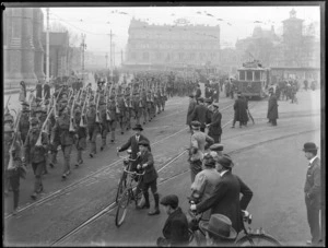 A view of World War I soldiers carrying their guns, marching through Cathedral Square, Christchurch