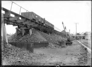 Railway yards, showing a crane and wagons on raised platform above [for loading shingle onto trains?], possibly Christchurch