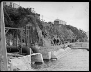 Group of men surveying a dam, location unidentified