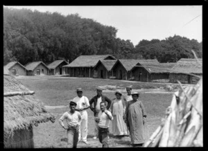 Maori men and women at model pas during the New Zealand International Exhibition, Christchurch