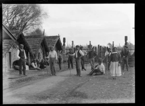 [South Seas Exhibition?], a Maori women and men at a marae exhibit demonstrating with wooden spears