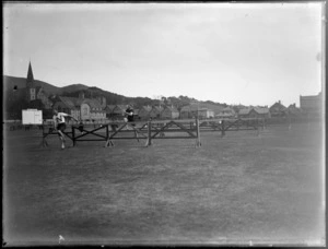 Athletes competing in a hurdles race at Basin Reserve, Wellington