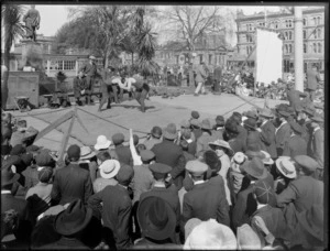 Crowds gather to watch a wrestling match in Cathedral Square, Christchurch