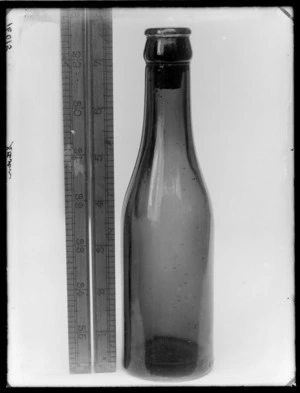 Glass bottle, including a ruler to measure height of bottle