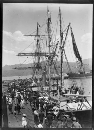 Crowd on Lyttelton Wharf, Christchurch, to witness the departure of the ship Nimrod for the Antarctic on the British Antarctic Expedition, showing the ship and men, women, and children gathered on wharf alongside