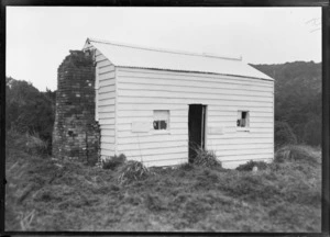 A wooden hut with a brick chimney, location unidentified