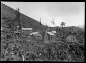 Wooden dwellings on a hillside, location unidentified