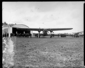 Biplane aircraft at an unidentified airport, showing aerodrome, officers and another aircraft