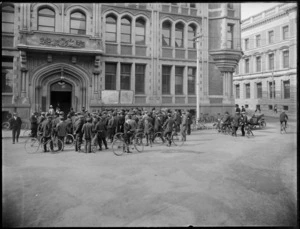 Large group of men, many with bicycles, gather outside the Christchurch Press building to hear news about World War One