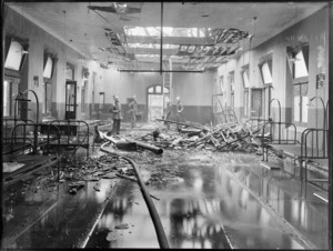 Christchurch Public Hospital, firemen stand in one of the burnt out wards, on standby with a fire hose to put out hot spots