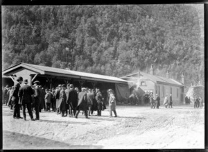 Arthur's Pass Railway Station, with the passengers standing in front of the station house