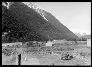 Midland Railway Line, Arthur's Pass, featuring horses, wooden buildings and a wooden railway bridge in the background