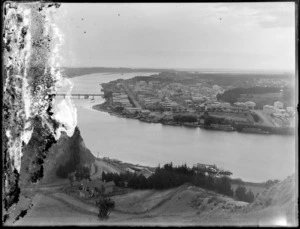 A view of Whanganui township and river, with ships docked along the shoreline