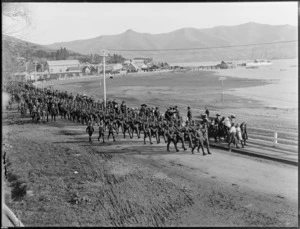 A parade procession of soldiers, marching along the shoreline, Akaroa, Canterbury
