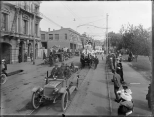 A parade procession through the streets of Christchurch, with soldiers in a motor car, Red Cross nurses on a wagon