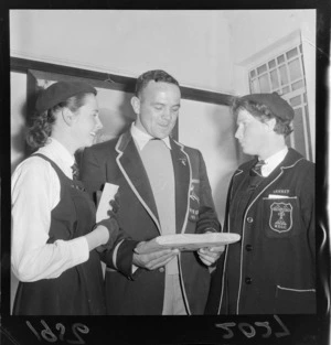 A J van der Merwe, Springbok rugby union football player on the 1956 tour, talking to two unidentified Wellington East Girls College pupils