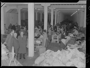 Sir Robert Macalister (Mayor of Wellington) watching Corso workers sorting clothes