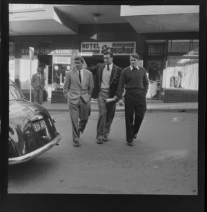 Jan Pickard (centre) with two other members of Springbok team, crossing Boulcott Street outside St George Hotel, Wellington