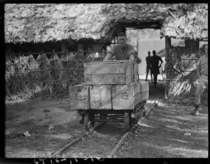 Private H Chalmers moving ration stores, New Caledonia