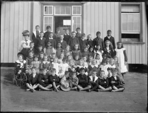 Pupils and teacher in front of school building, Northland