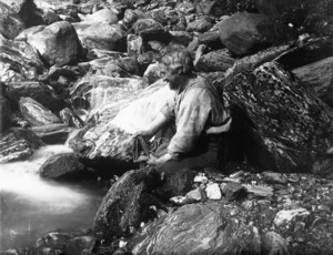 Harper, Arthur Paul, 1865-1955 :Charles Edward Douglas, washing his shirt in a glacial river