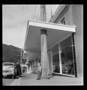 Shop verandah built around a wooden telegraph pole, Wainuiomata