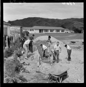 Volunteers digging a hole for a swimming pool in Wainuiomata School grounds