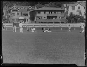 Cricket match between Wellington and Hutt Valley at Basin Reserve, including Seaforth flats, Wellington East Girls' College and [St Mark's School?] in the background