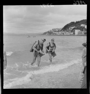 United States Frogmen come out of the water in scuba diving equipment, Oriental Bay, Wellington