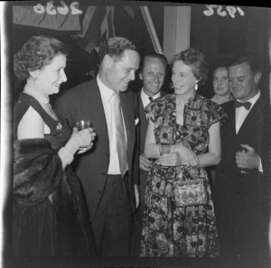 Unidentified guests with double-amputee and World War II veteran Douglas Robert Steuart Bader and his wife Thelma at a cocktail party
