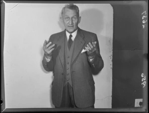 Campaign portrait of Julius Hyde, 1956 mayoral candidate for Wellington, gesticulating