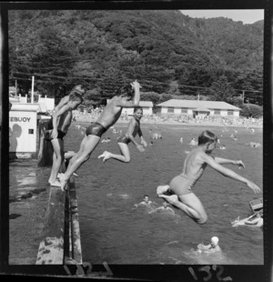 Boys jumping off wharf at Days Bay, Eastbourne