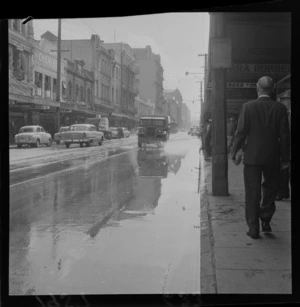 Minor flooding on Willis Street, Wellington, following a water main breaking, including businesses Para Rubber, Grand Hotel, Boots Chemist and Thompson's Silk Shop Limited