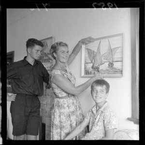 Mrs H J U Walker and her sons with some of her paintings