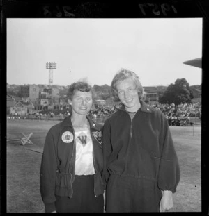 Two unidentified young women, one wearing a Lower Hutt Amateur Athletics Association badge, at an athletics event at the Basin Reserve, Wellington
