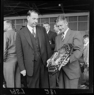 Two unidentified men looking at the Plunket Shield, part of the Wellington cricket team