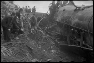Police and others alongside a wrecked carriage at the scene of the railway disaster at Tangiwai