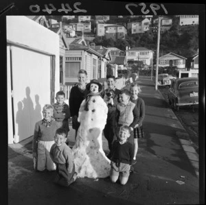 Unidentified children on a Wellington street with a snowman they built after a hailstorm