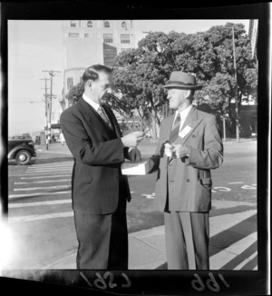 Wellington Mayor Frank Kitts donating to an unidentified street collector on his way to work