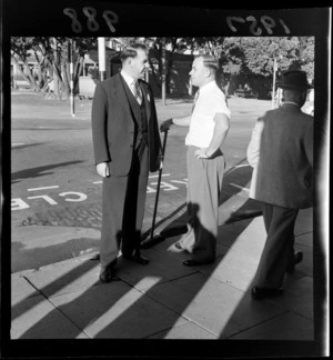 Wellington Mayor Frank Kitts talking to an unidentified man on his way to work